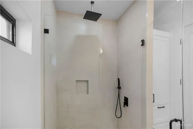 a bathroom with a granite countertop sink and a toilet