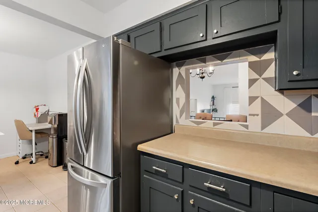 a kitchen with a refrigerator and cabinets