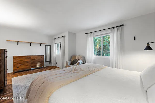 a bedroom with a large bed and a tv