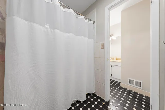 a bathroom with a sink and a shower