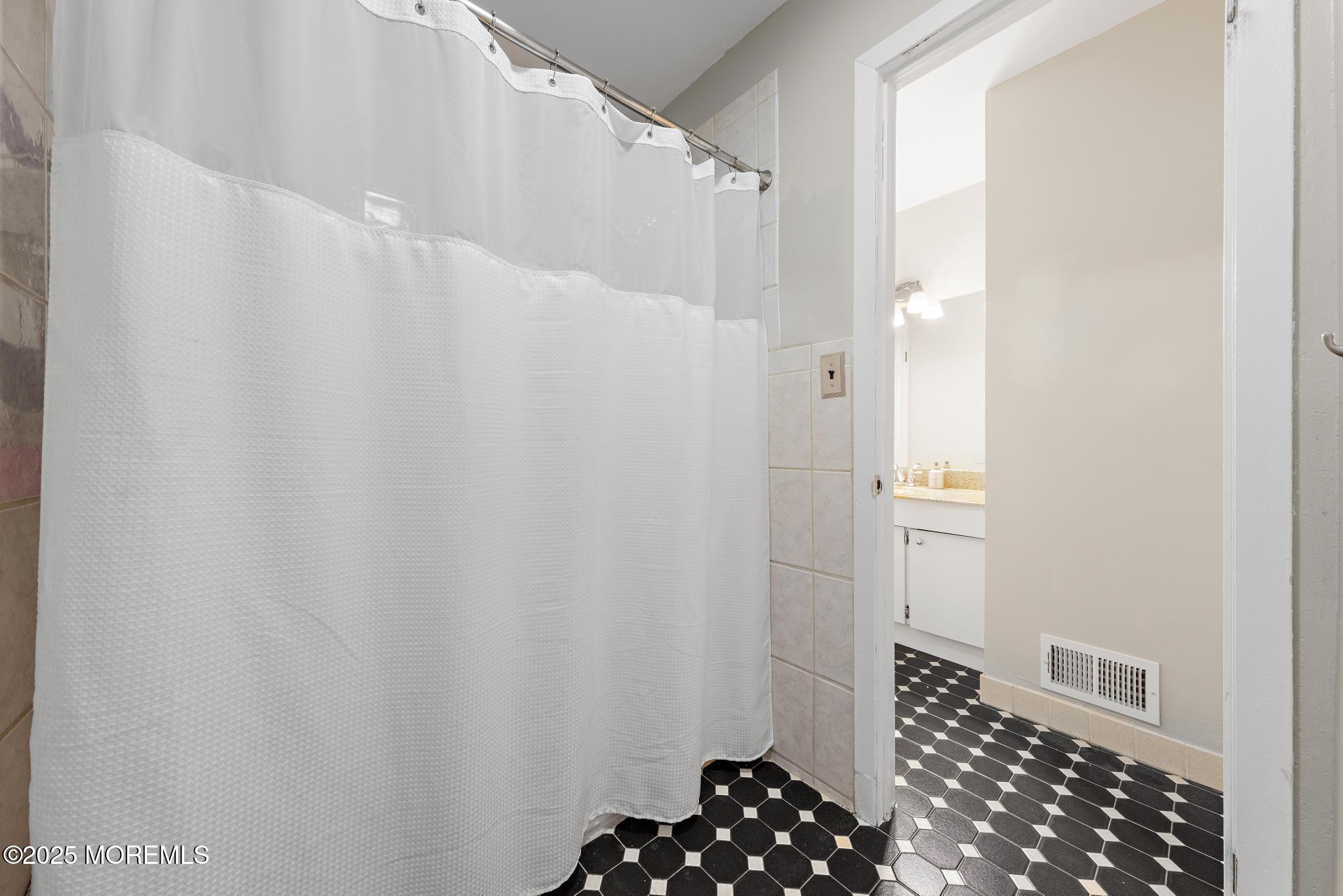 343 Middlewood Road Middletown, NJ 07748 - Photo 24 of 30 a bathroom with a sink and a shower