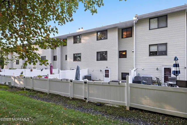 a view of house that has a lot of plants and trees