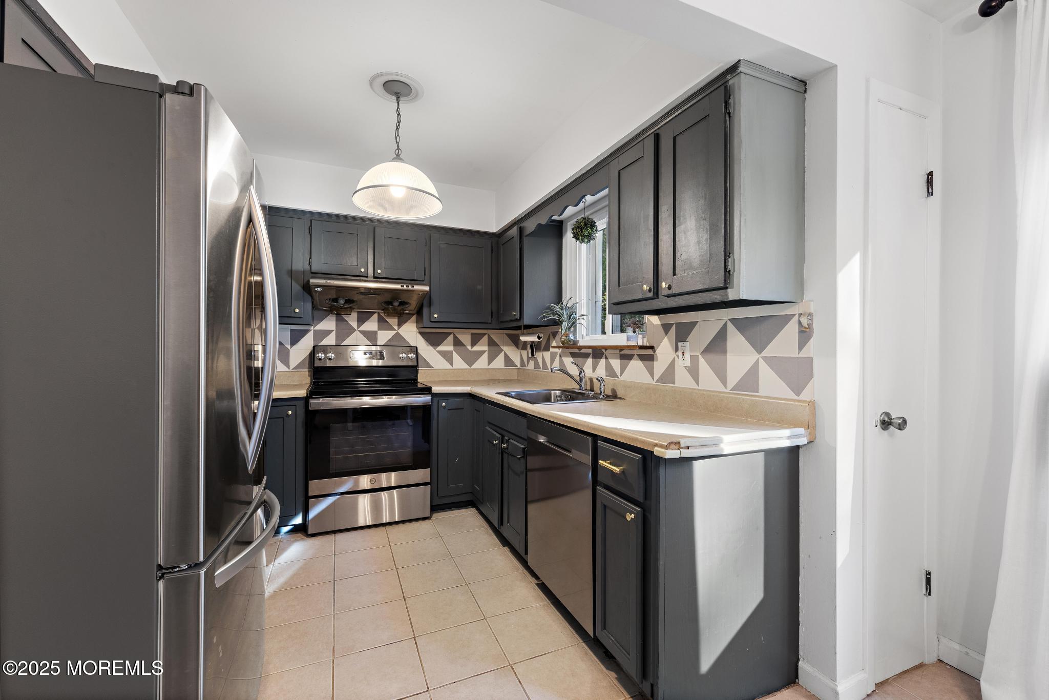 343 Middlewood Road Middletown, NJ 07748 - Photo 7 of 30 a kitchen with a sink stove and refrigerator