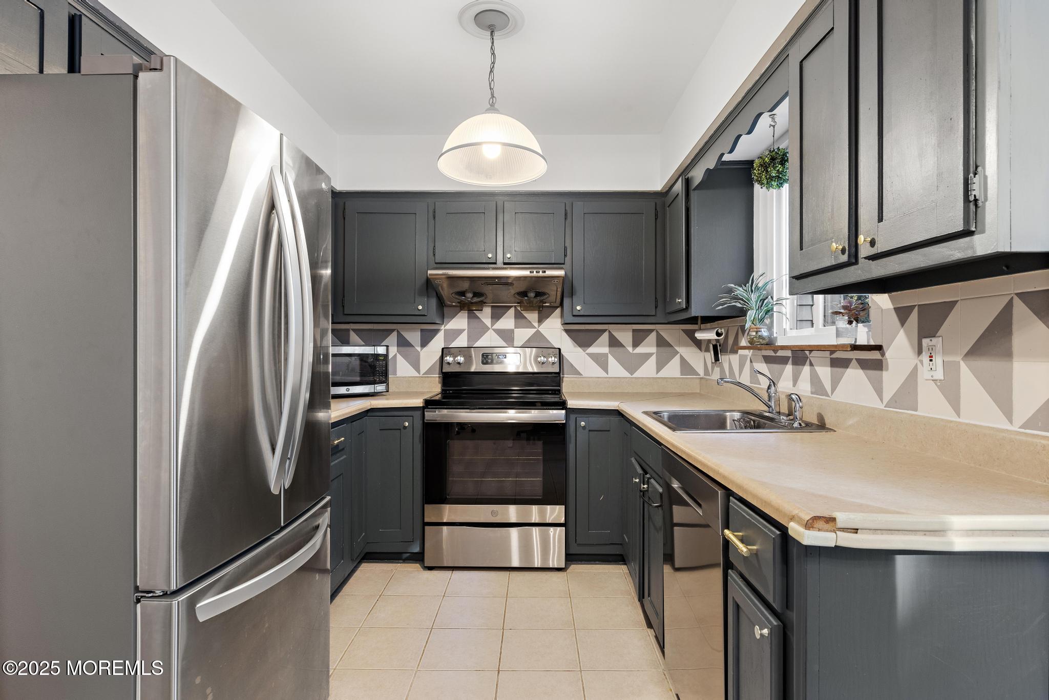 343 Middlewood Road Middletown, NJ 07748 - Photo 8 of 30 a kitchen with stainless steel appliances granite countertop a sink and a refrigerator