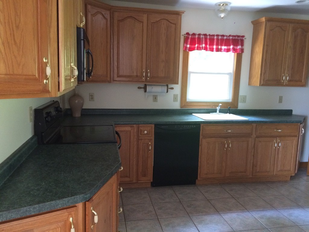 17 Chesterfield Road Worcester, MA 01602 - Photo 4 of 16 a kitchen with granite countertop cabinets sink and window