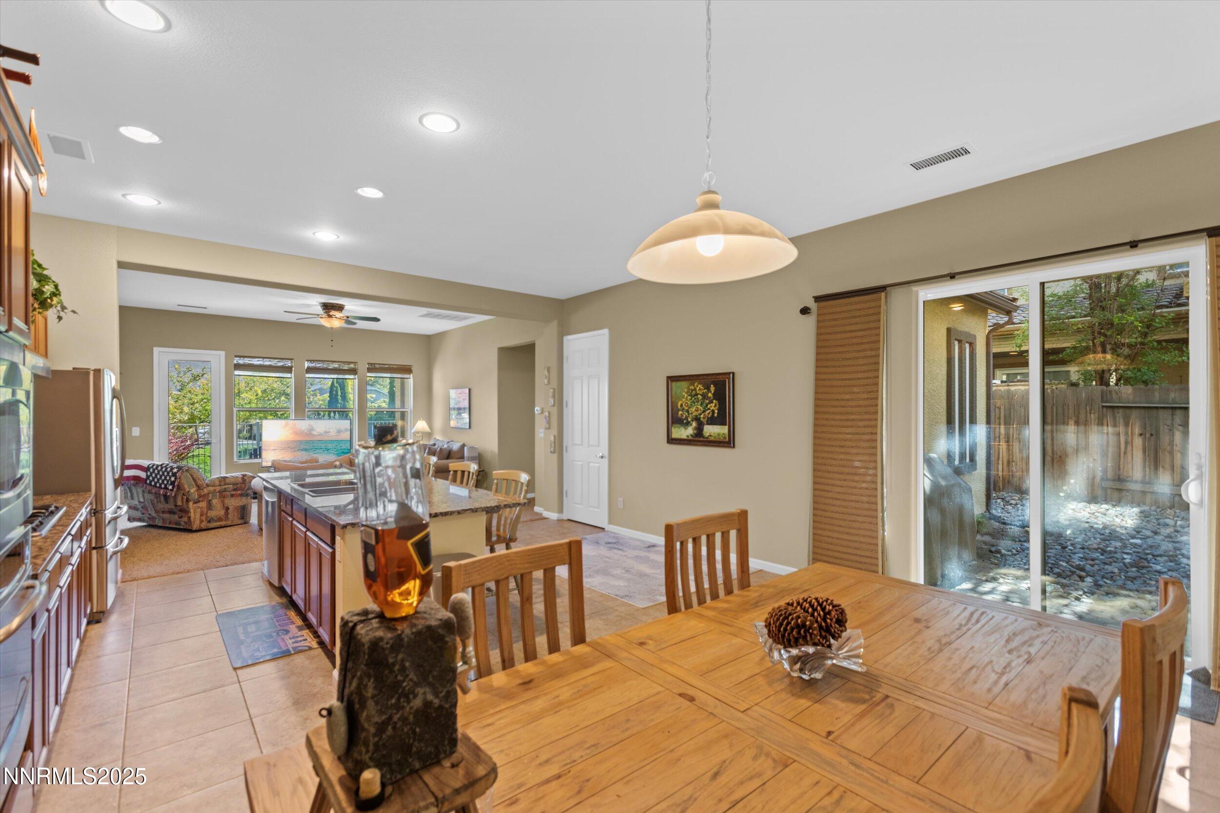 10900 Serratina Drive Reno, NV 89521 - Photo 13 of 47 a view of a dining room with furniture window and outside view