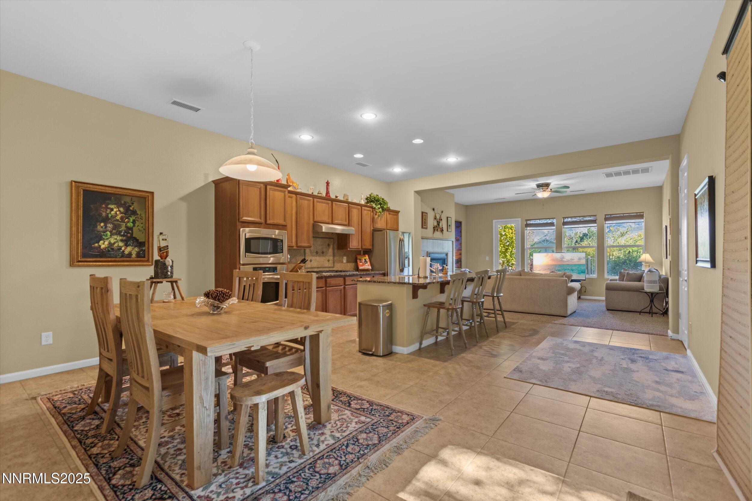 10900 Serratina Drive Reno, NV 89521 - Photo 14 of 47 a view of a dining room with furniture