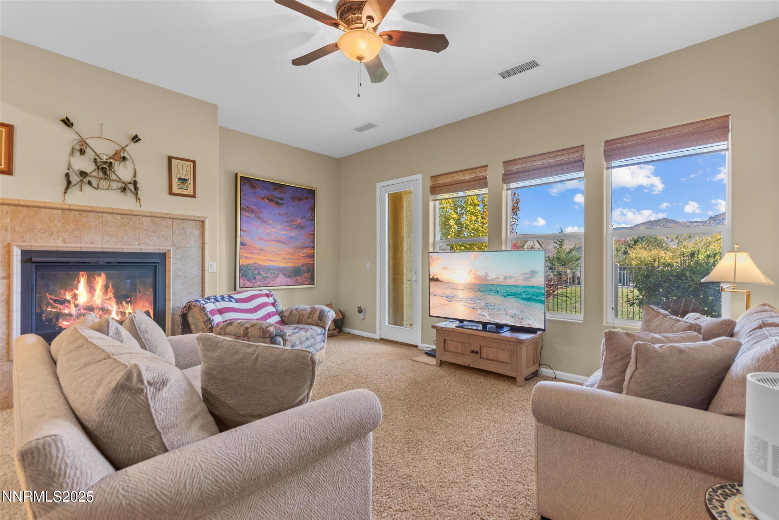 10900 Serratina Drive Reno, NV 89521 - Photo 16 of 47 a living room with furniture and a chandelier