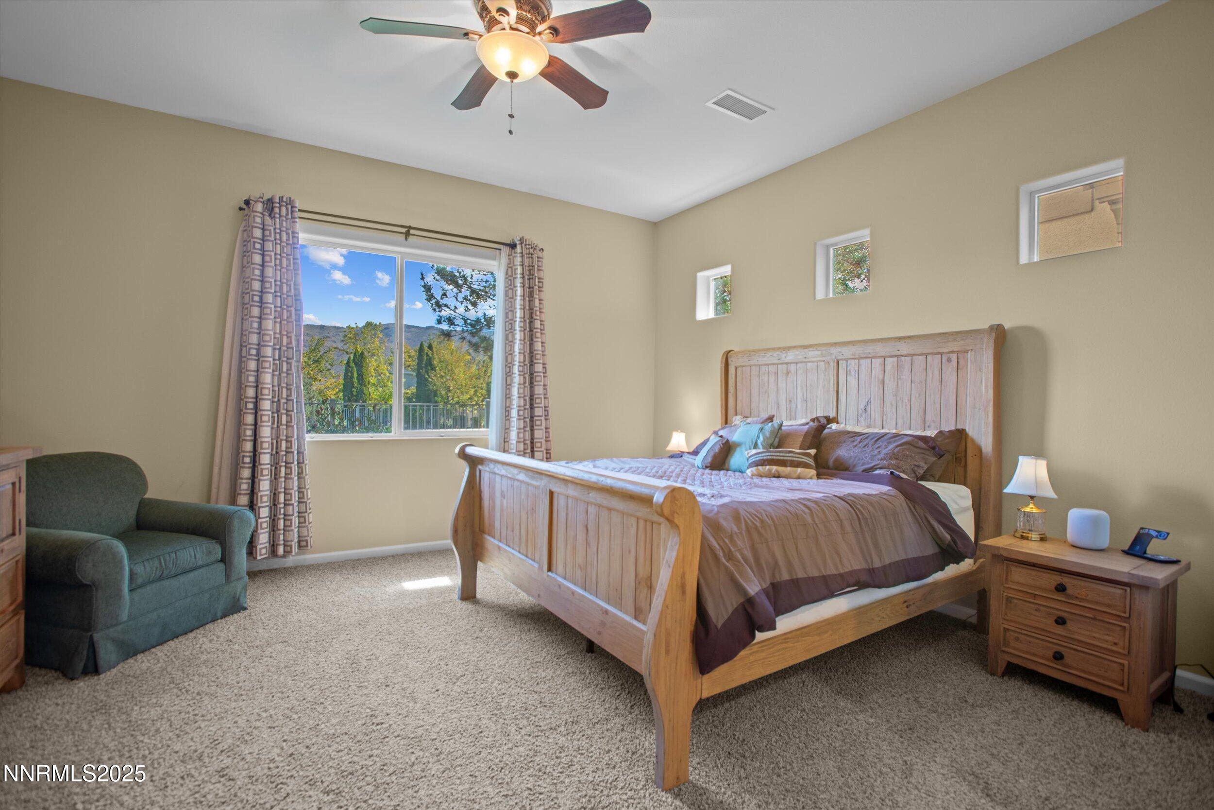 10900 Serratina Drive Reno, NV 89521 - Photo 18 of 47 a bed room with a bed and a chair
