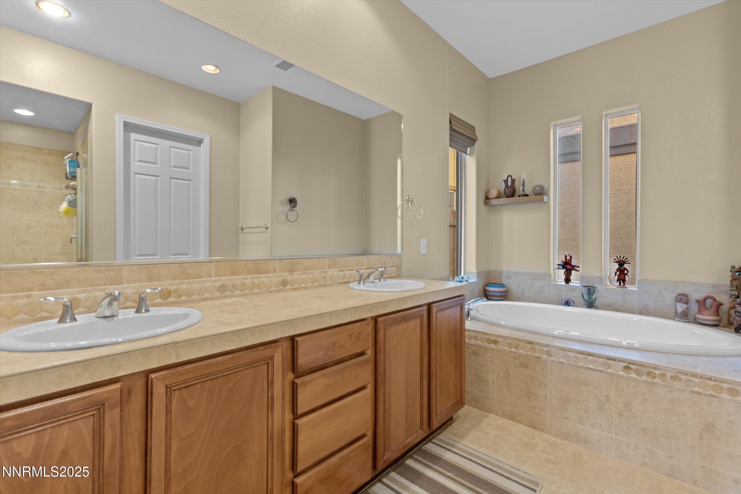 10900 Serratina Drive Reno, NV 89521 - Photo 20 of 47 a bathroom with a double vanity sink mirror and