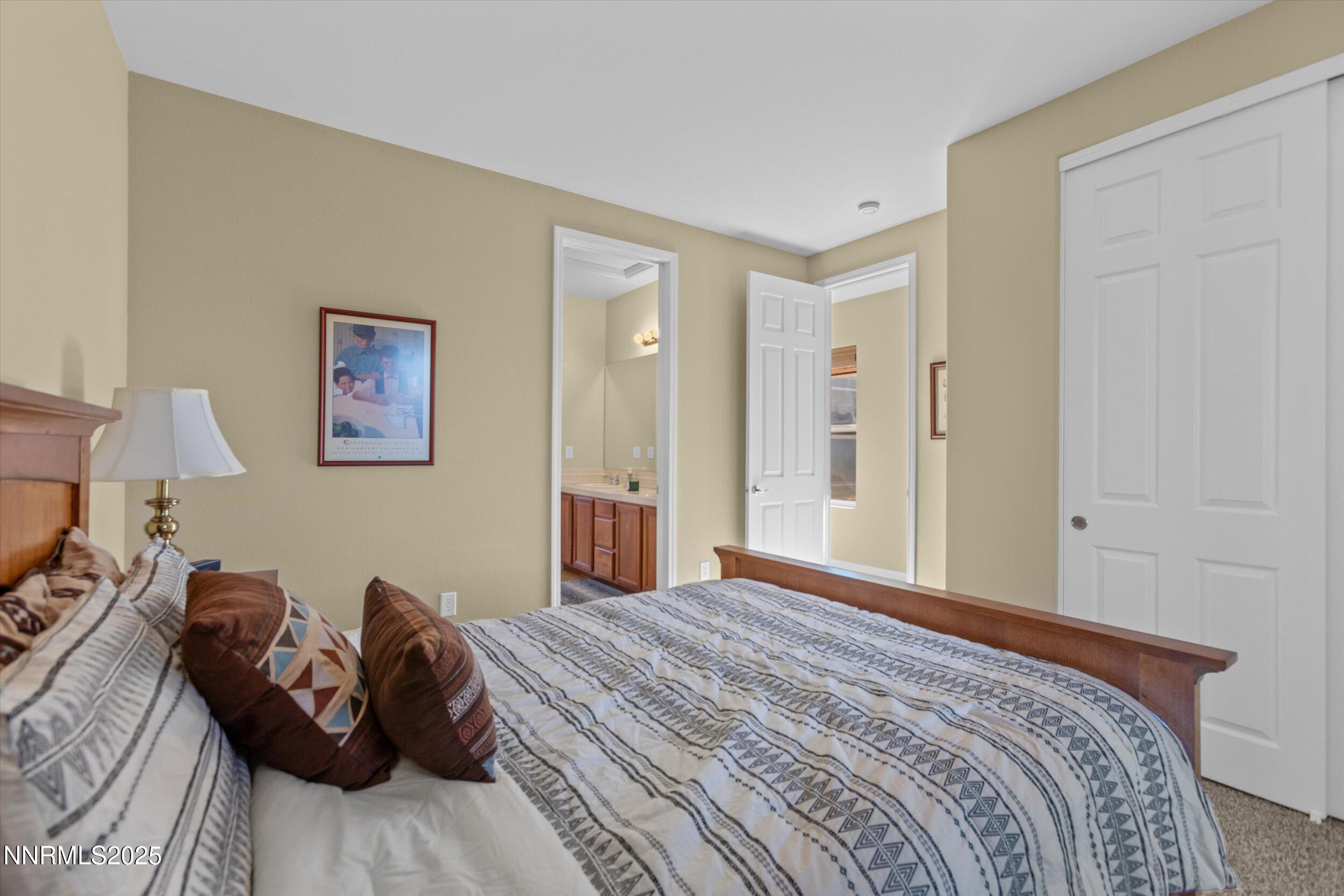 10900 Serratina Drive Reno, NV 89521 - Photo 23 of 47 a bedroom with a bed and couch