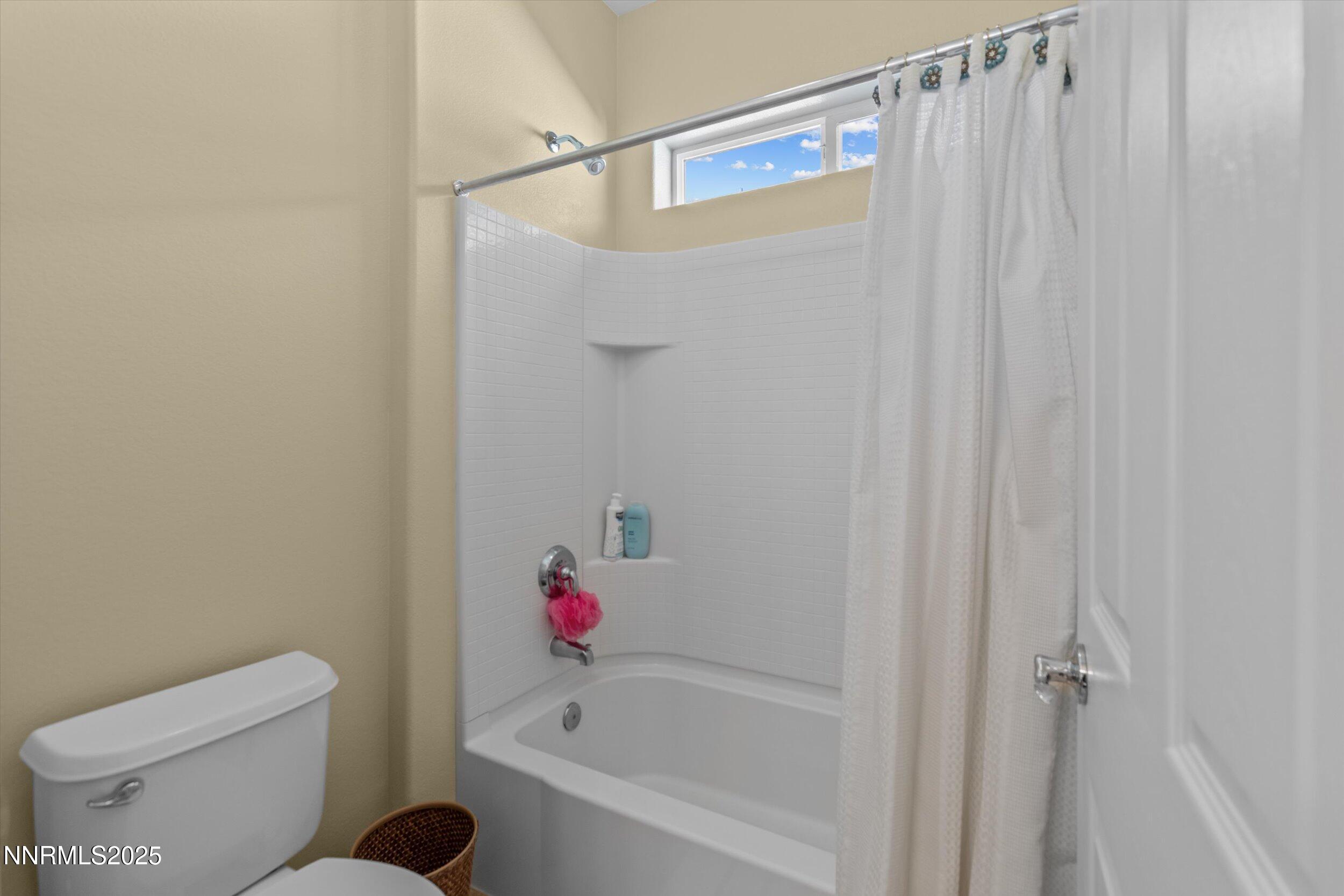 10900 Serratina Drive Reno, NV 89521 - Photo 25 of 47 a bath room with a toilet and a bath tub