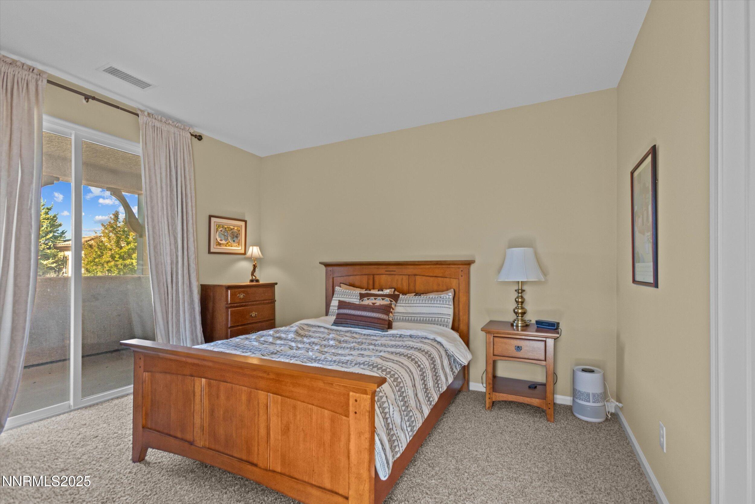 10900 Serratina Drive Reno, NV 89521 - Photo 27 of 47 a bedroom with a bed and a night stand