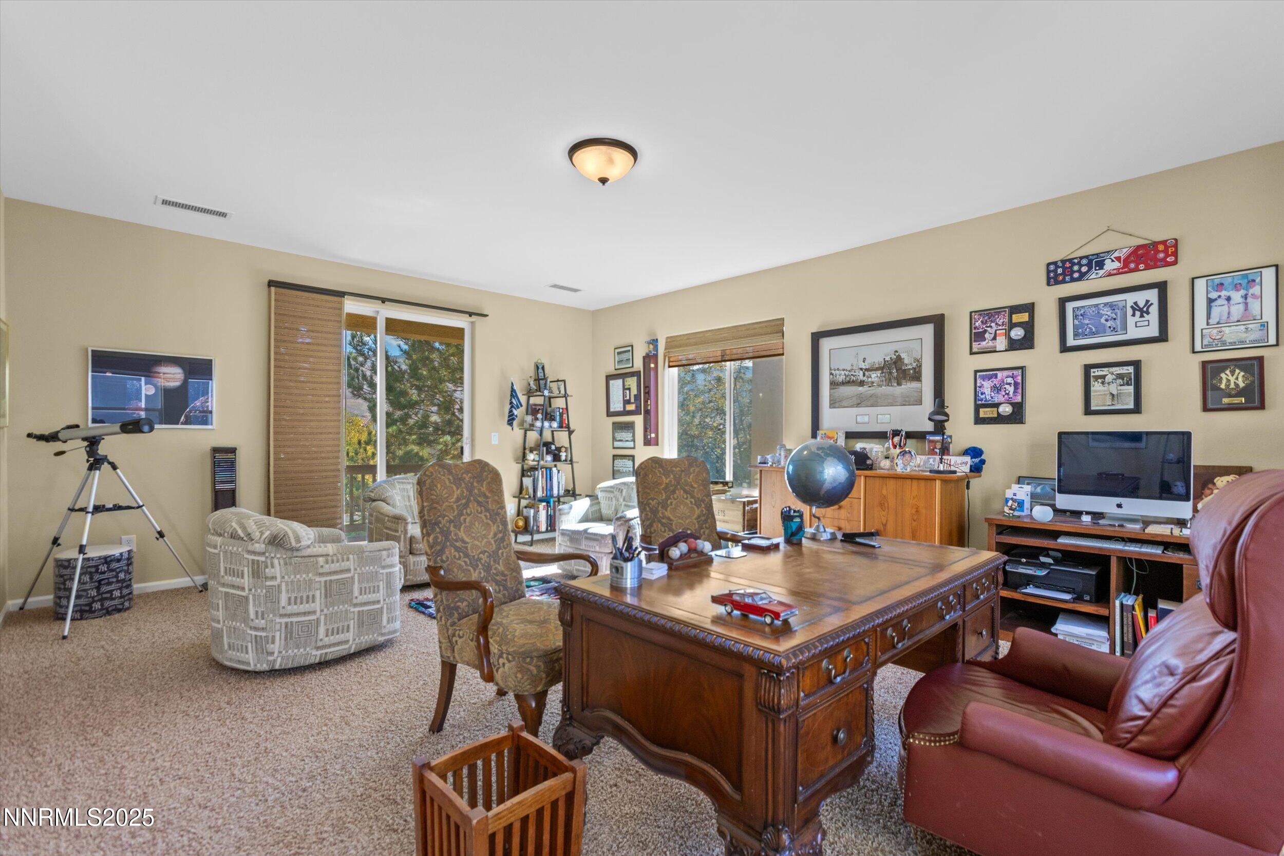 10900 Serratina Drive Reno, NV 89521 - Photo 32 of 47 a living room with furniture a flat screen tv and a window