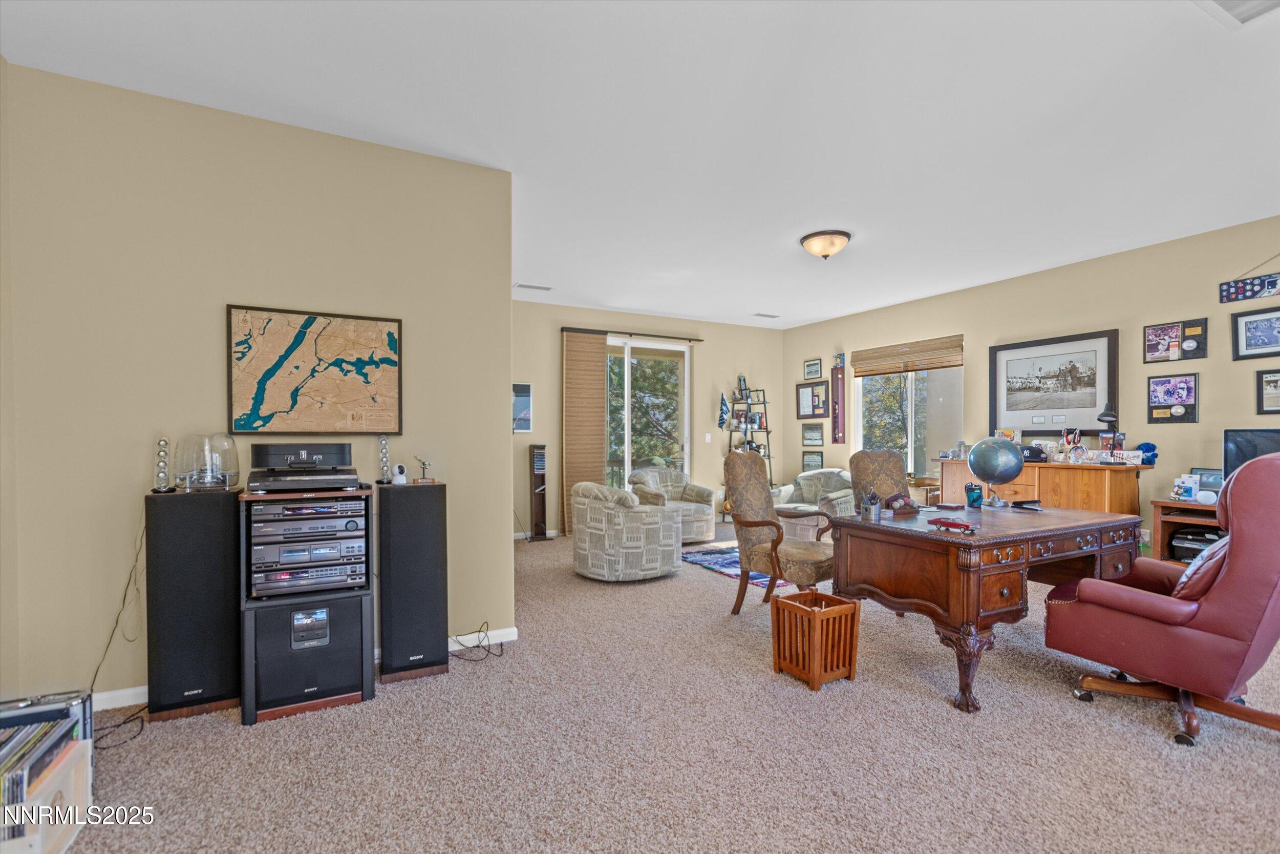 10900 Serratina Drive Reno, NV 89521 - Photo 33 of 47 a living room with furniture and a baby crib