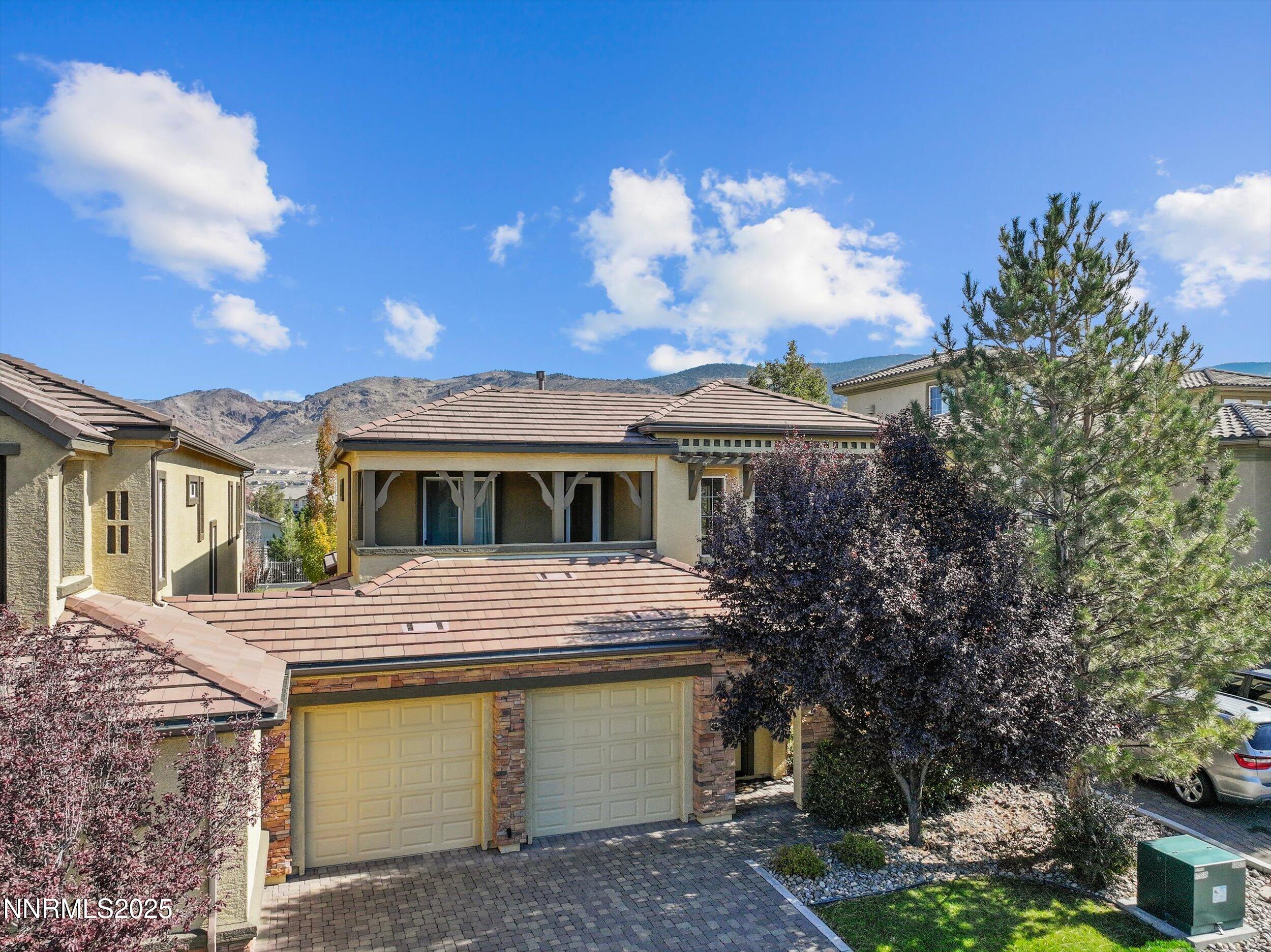 10900 Serratina Drive Reno, NV 89521 - Photo 38 of 47 a front view of a house with a yard and lake view