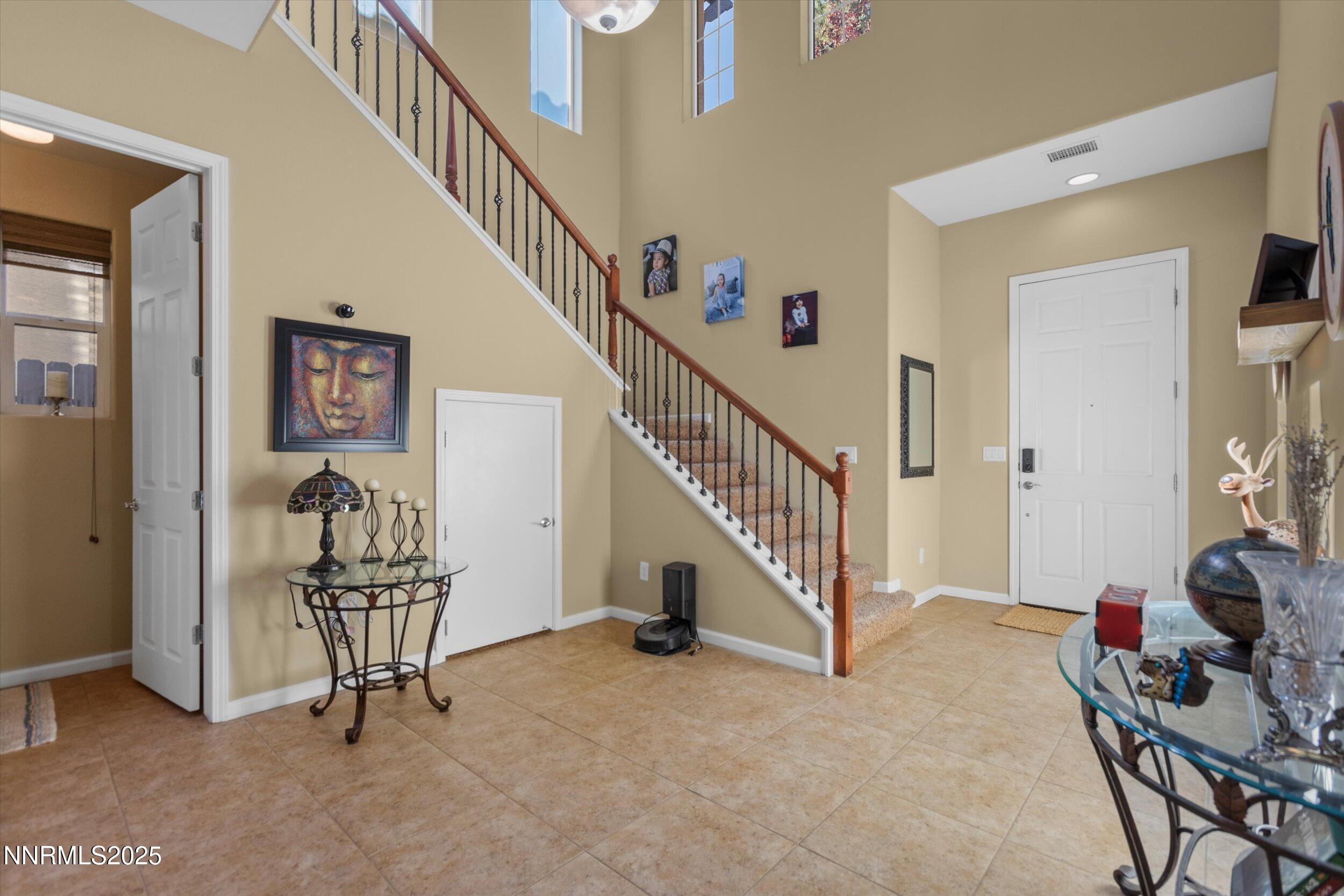 10900 Serratina Drive Reno, NV 89521 - Photo 5 of 47 a view of staircase with furniture and a rug