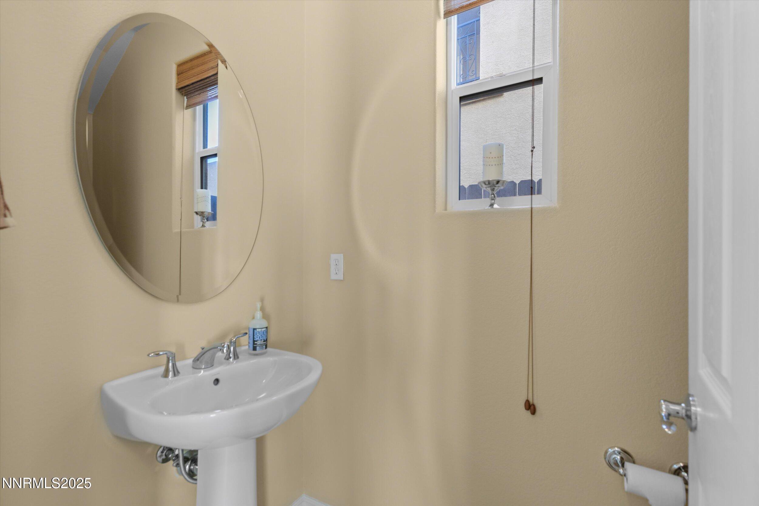 10900 Serratina Drive Reno, NV 89521 - Photo 6 of 47 a bathroom with a sink a mirror and a shower