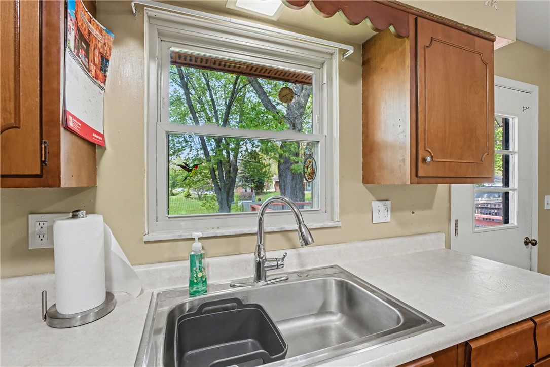 4919 Silver Arrow Drive Riverside, OH 45424 - Photo 19 of 57 This kitchen offers a practical workspace with a window overlooking lush greenery.