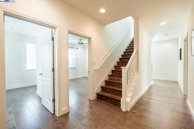 a view of a hallway with wooden floor and entryway