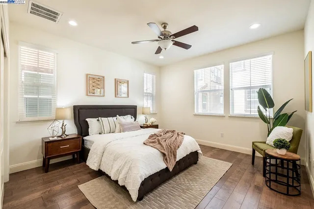 a bedroom with a bed and wooden floor