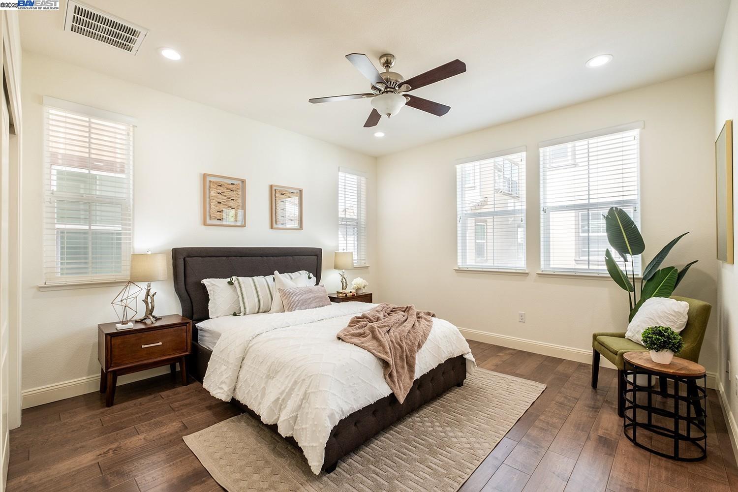 3135 Vittoria Loop Dublin, CA 94568 - Photo 13 of 38 a bedroom with a bed and wooden floor