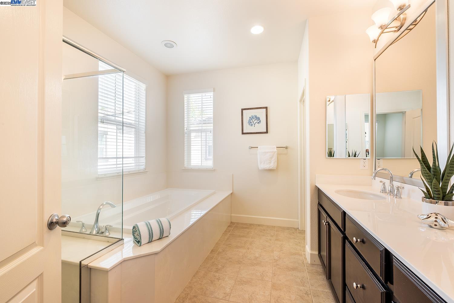 3135 Vittoria Loop Dublin, CA 94568 - Photo 16 of 38 a bathroom with a tub sink and mirror