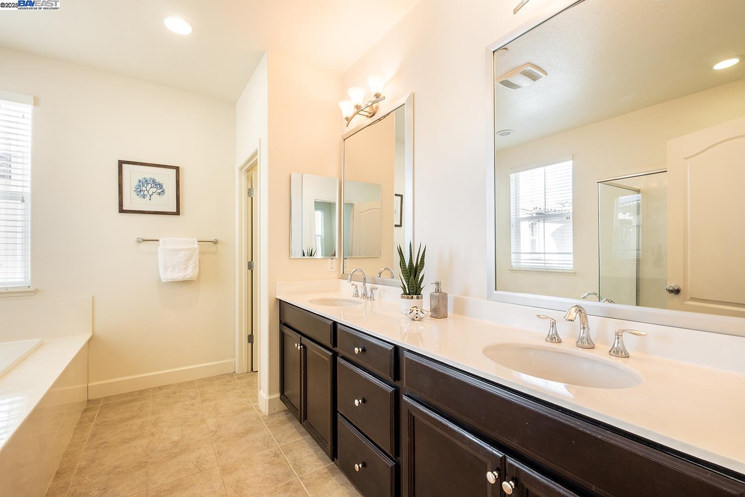 3135 Vittoria Loop Dublin, CA 94568 - Photo 17 of 38 a bathroom with a double vanity sink a mirror and a shower