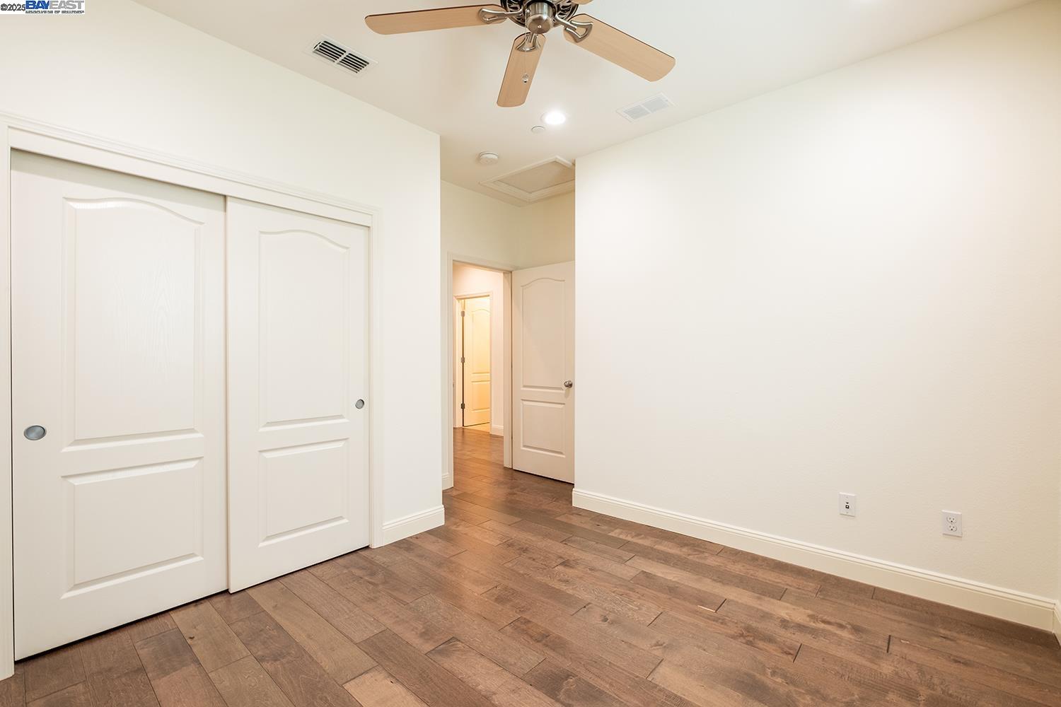 3135 Vittoria Loop Dublin, CA 94568 - Photo 20 of 38 an empty room with a ceiling fan and carpet