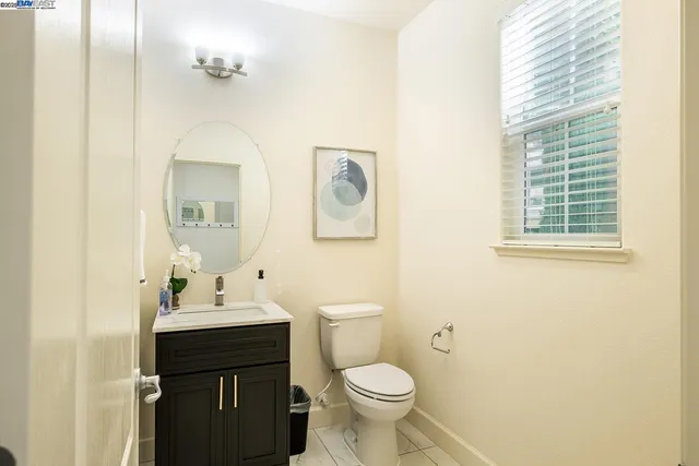 a bathroom with a double vanity sink toilet and a mirror