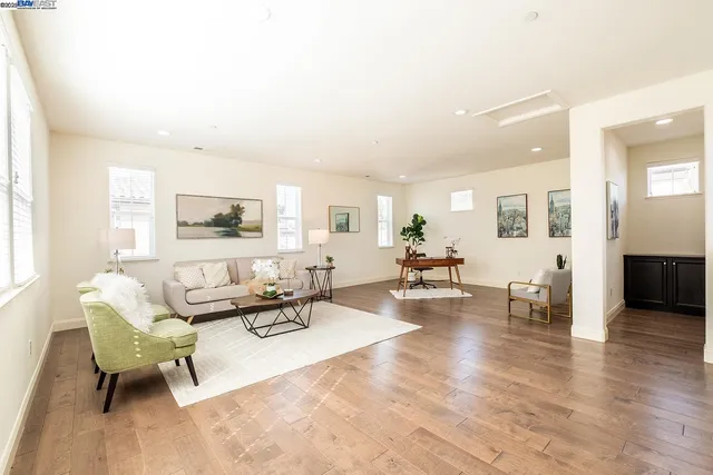 a living room with furniture and wooden floor