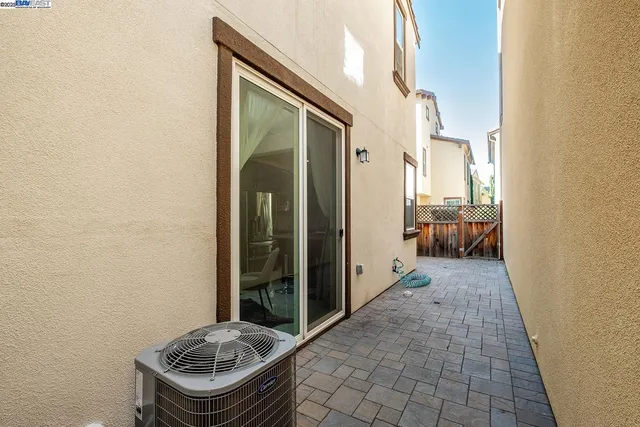 a view of a hallway with bathroom and balcony