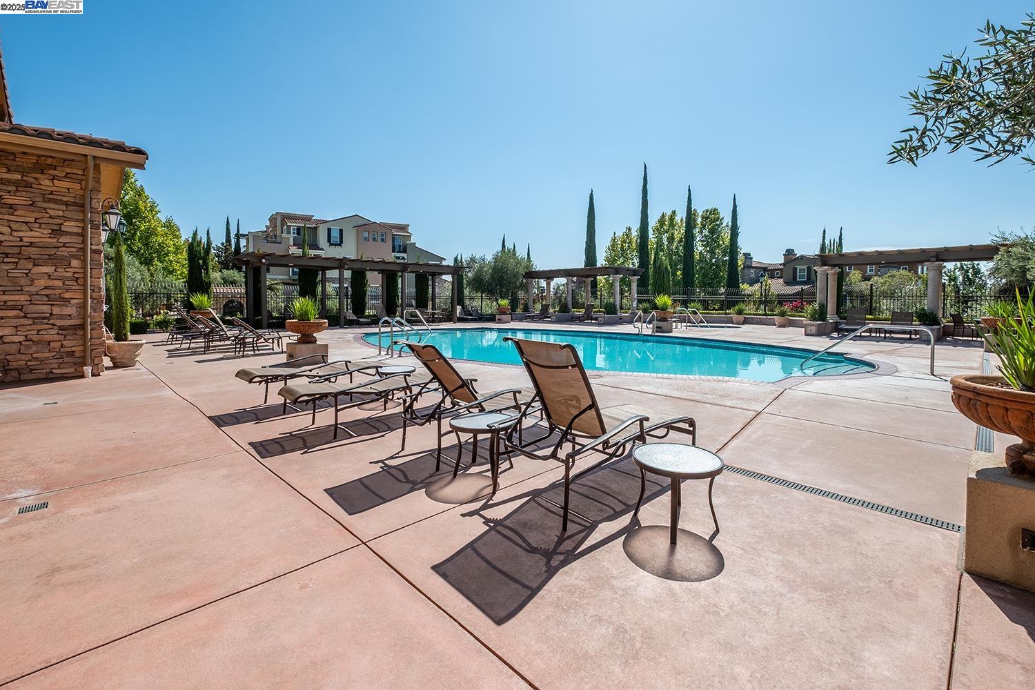 3135 Vittoria Loop Dublin, CA 94568 - Photo 30 of 38 a view of a swimming pool with outdoor seating and plants