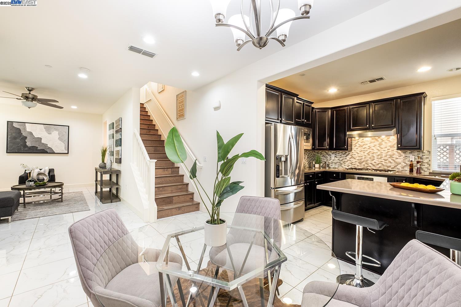 3135 Vittoria Loop Dublin, CA 94568 - Photo 5 of 38 a living room with furniture kitchen view and a wooden floor