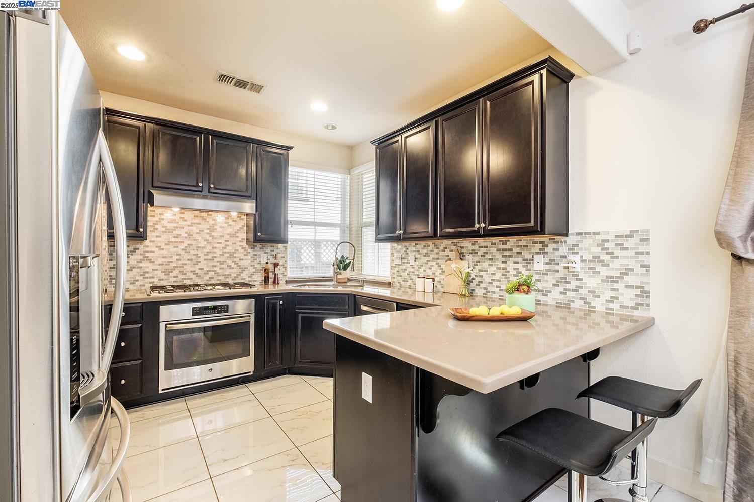 3135 Vittoria Loop Dublin, CA 94568 - Photo 6 of 38 a kitchen with a sink cabinets and stainless steel appliances