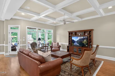 a dining room with furniture a rug and a chandelier