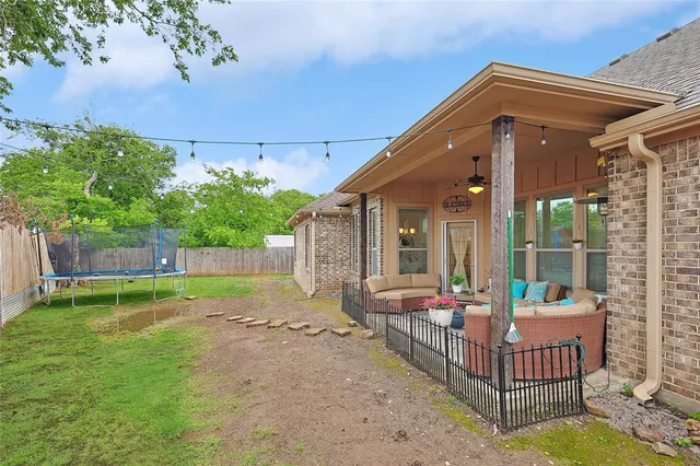 a view of house with backyard and porch