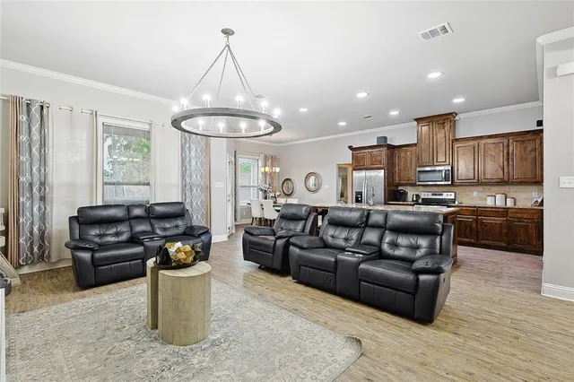 a living room with furniture and a kitchen view