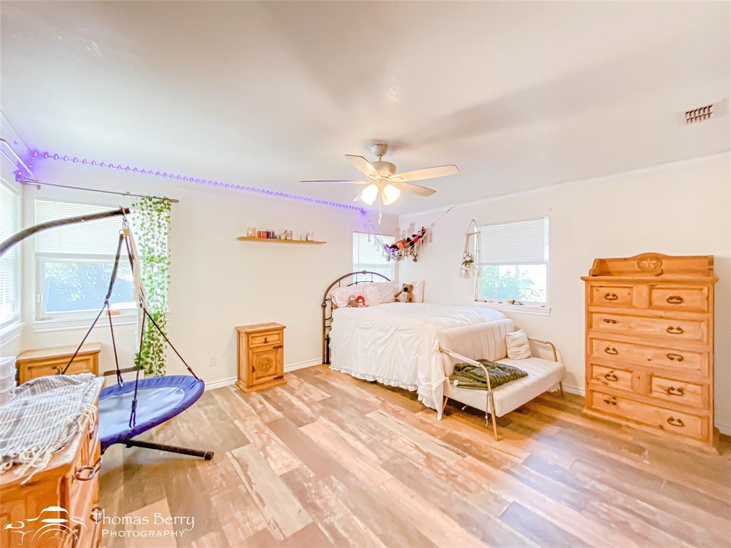 355 Farm To Market 604 Clyde, TX 79510 - Photo 11 of 30 a spacious bedroom with a bed a rug and dresser