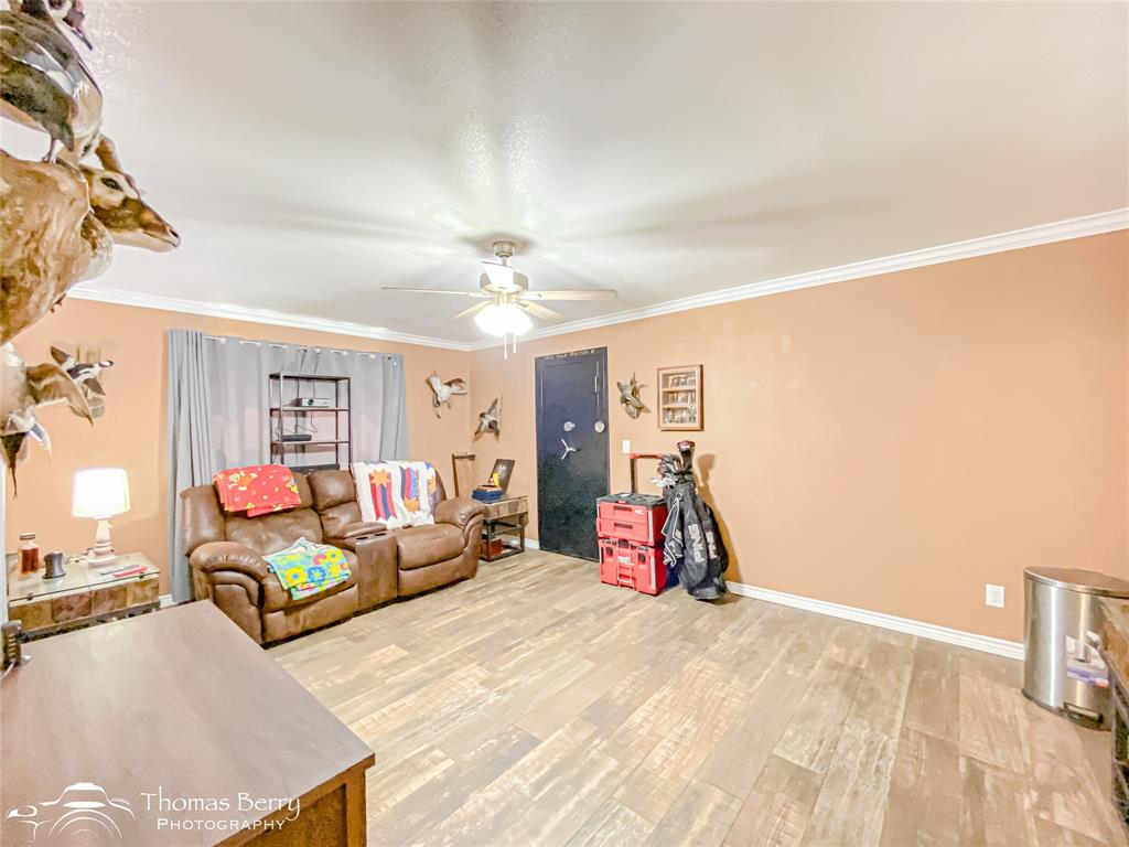 355 Farm To Market 604 Clyde, TX 79510 - Photo 22 of 30 a bedroom with furniture and a chandelier