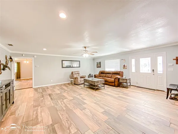 a view of a livingroom with furniture and a flat screen tv