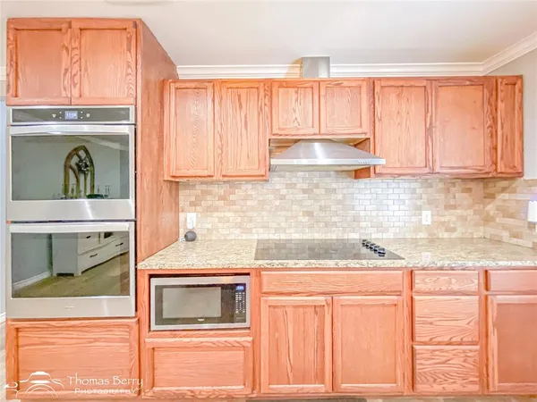 a kitchen with granite countertop cabinets stainless steel appliances and a sink
