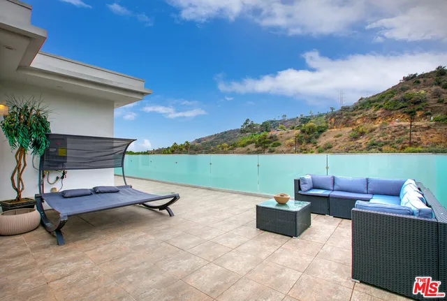 a view of a patio with a table and chairs