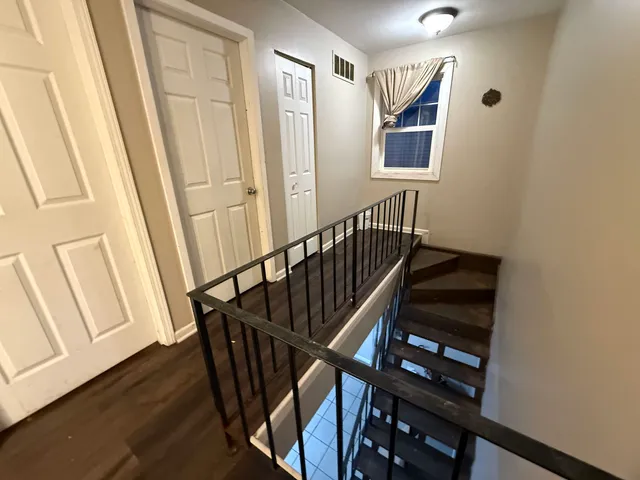 a view of entryway with wooden floor and stairs