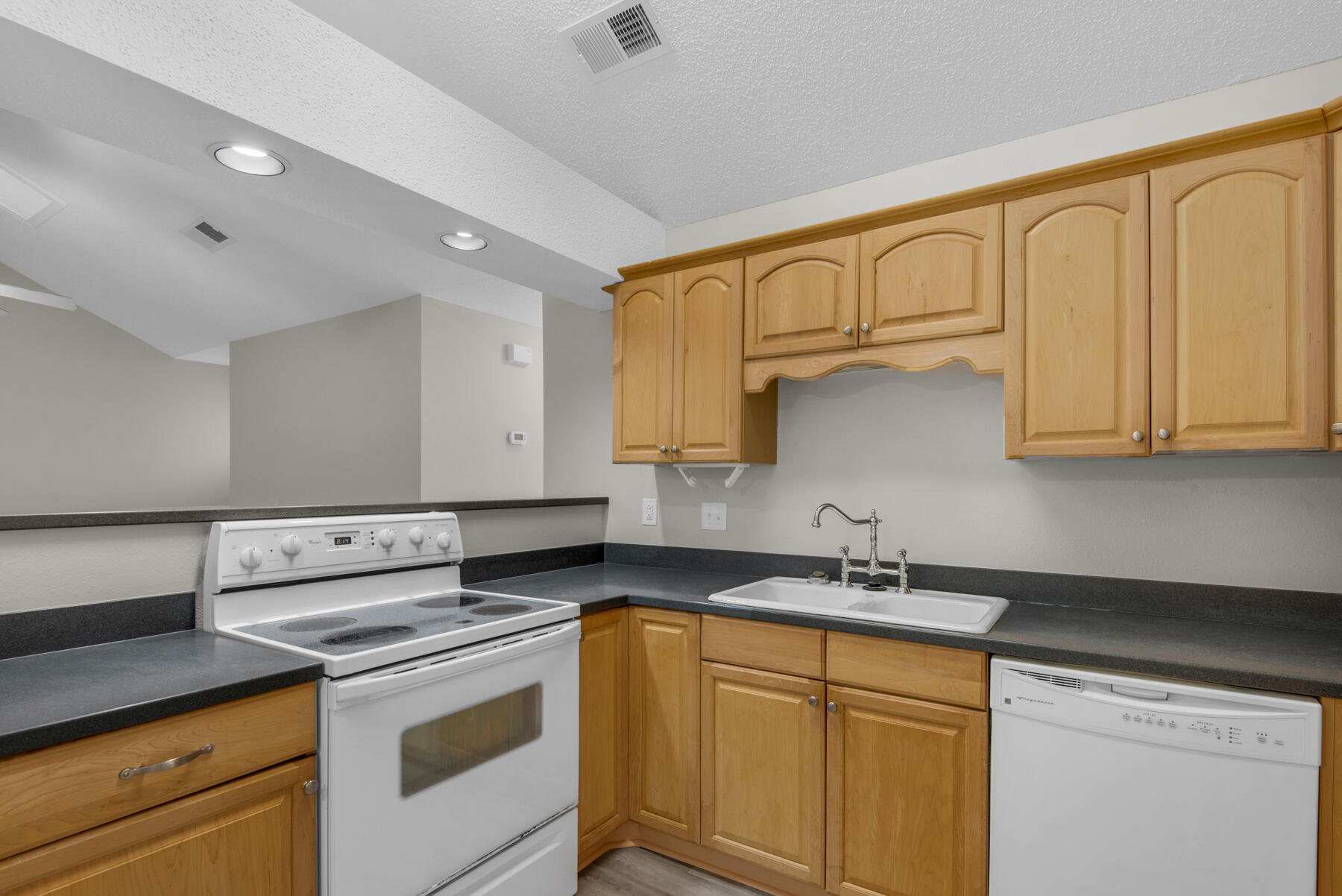 2 Falcon Ridge Lane Fort Walton Beach, FL 32547 - Photo 10 of 24 a kitchen with granite countertop white cabinets and white appliances