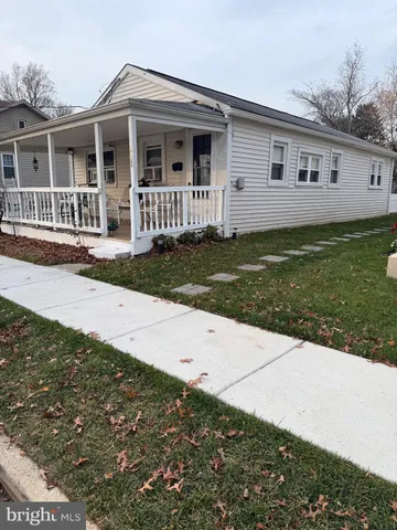 a view of a house with a yard and wooden fence