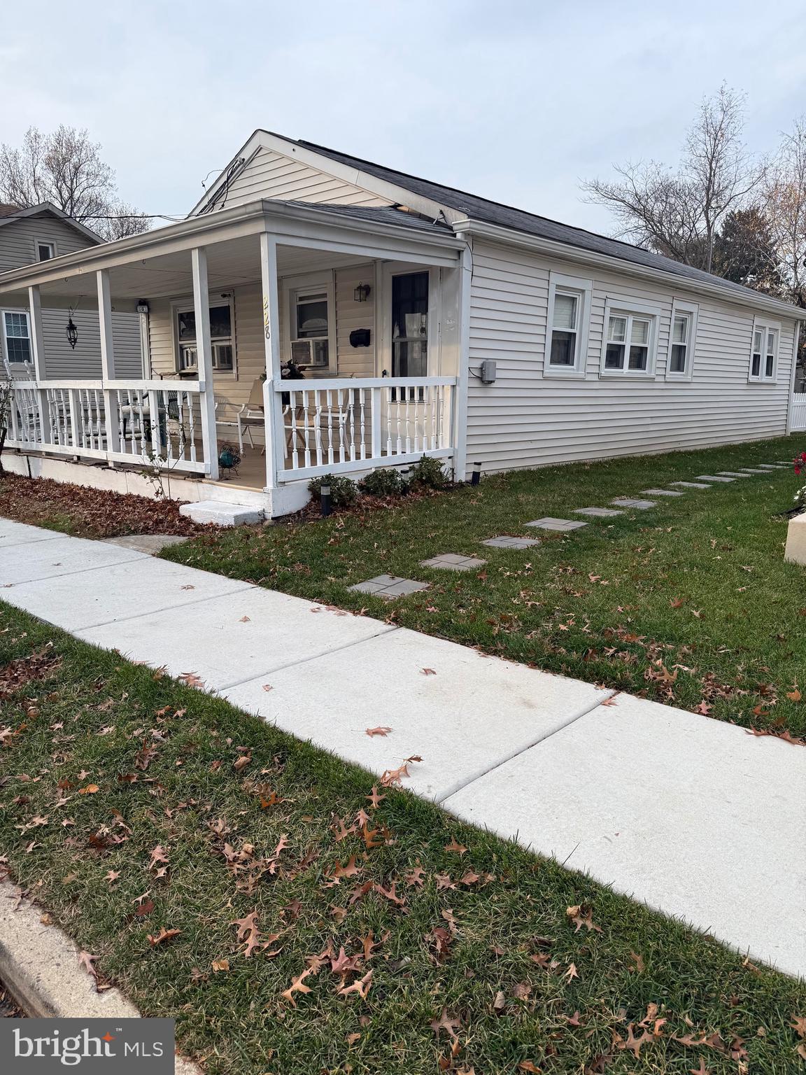 a view of a house with a yard and wooden fence
