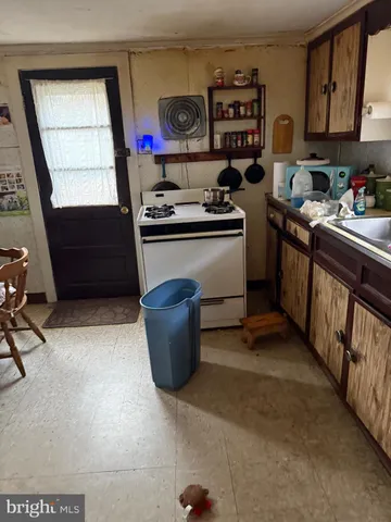 a kitchen with stainless steel appliances a stove a sink and a refrigerator