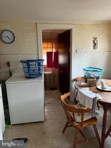 a dining room with furniture and a mirror