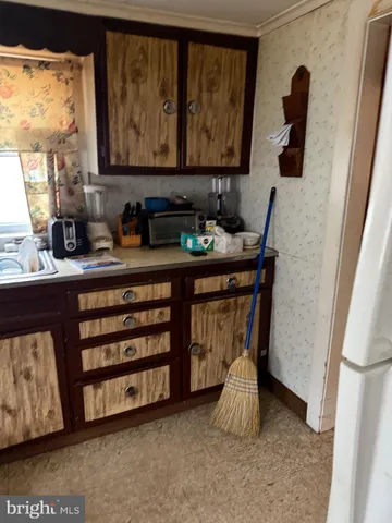 a room with a baby bed furniture and a window